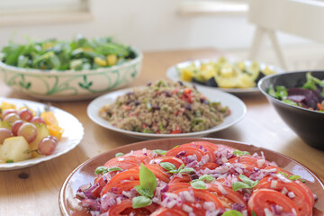Fresh salad with garnishing and meal on table