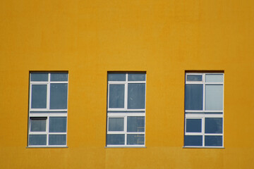 three Windows in the yellow wall