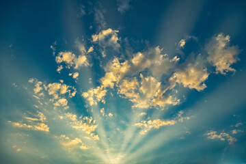 Heaven dreaming sunset with sun rays penetrating cloudy sky.