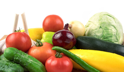 Lots of fresh different vegetables with water drops on a white background. Food background. Side view. The concept of natural products, proper nutrition.