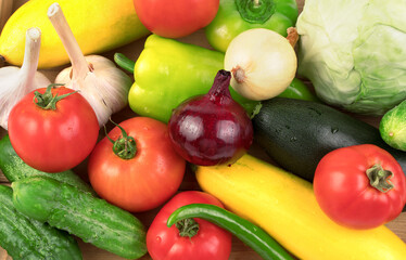 Washed fresh vegetables in large quantities on a white background with water drops. Food background. Side view. The concept of natural products, proper nutrition.