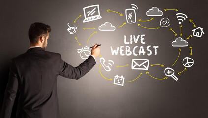 businessman drawing social media icons with LIVE WEBCAST inscription, new media concept