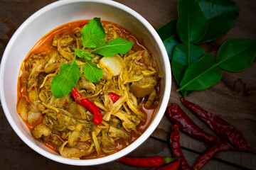 Mhok Bamboo is the Thai food. Thai Esan style steamed bamboo shoot, pork belly, onions, mushroom as medium spicy in a white bowl.
