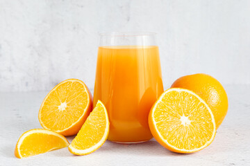 Fresh orange juice in a glass. Lots of juicy sliced oranges