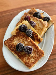 French Toast with Blackberries in Plate on Wooden Table.