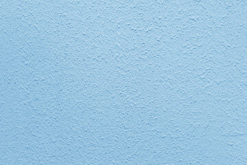 Light blue wall of the building. Rough plaster surface. Abstract background.