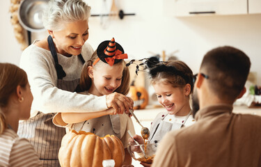 Multi generational family preparing for Halloween in kitchen.