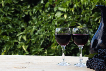  two glasses of red wine on blur green background