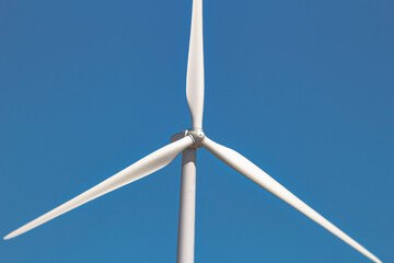 Close up, front view of a wind tower turbine electricity gererator, renewable energy source.