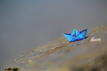 small wooden blue toy boat on a bright background