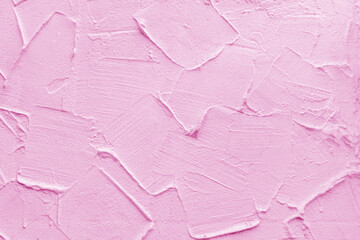 Pink wall of the building. Rough plaster surface. Abstract background.
