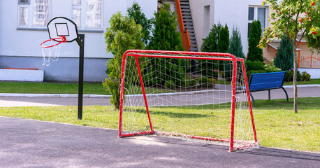 football gate in red frame and backboard on sport court in kindergarten