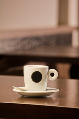 Fresh hot coffee on wooden table in cafe interior and free space for your decoration.