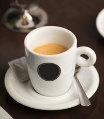 Fresh hot coffee on wooden table in cafe interior and free space for your decoration.