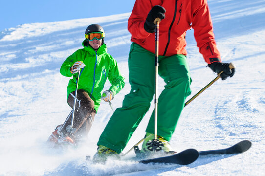 Skifahrerin und Telemarker gemeinsam auf der Piste unterwegs