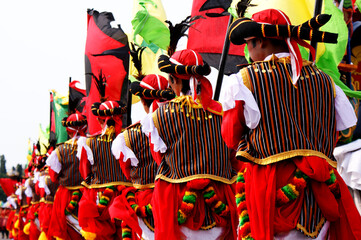 People are lining up in traditional costume for the parade.