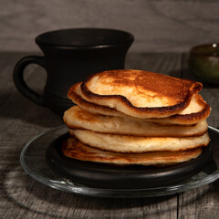 Several pancakes on wood background