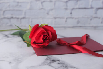 envelope and rose flower on white background 