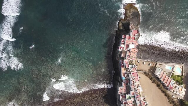 Aerial view of a rocky beach with a very little town in the north coast of Gran Canaria