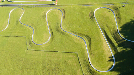 Amazing drone aerial view of a summer bobsleigh track. Passo della Presolana. Bergamo, Italy....