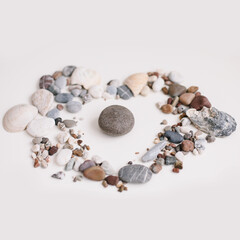Fototapeta premium Soap with seashells and stones on a white background. Spa or wellness setting. Top view mockup