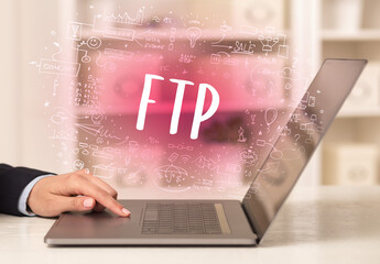 hand working on new modern computer with FTP abbreviation, modern technology concept