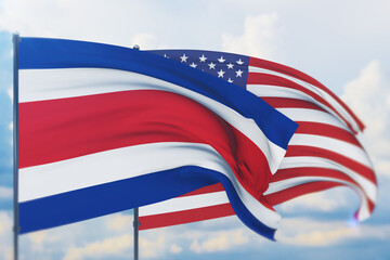 Waving American flag and flag of Costa Rica. Closeup view, 3D illustration.