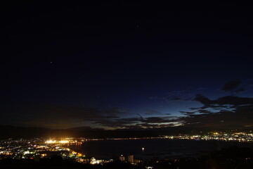 A wide shot looking out over the Lake and the city in Japan during a summer sunset.