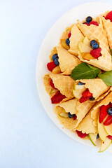 Close-up plate with berries, strawberries. raspberries, cherries, blueberries, and baked goods. Buffet table at the festival. Catering concept