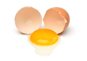 Chicken eggs and half with yolk isolated on a white background.