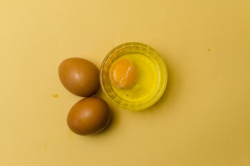 fresh chiken egg and yolk on background