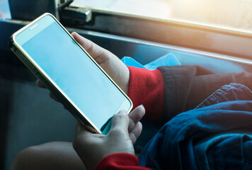 People are using their phones on buses.And the sun shines