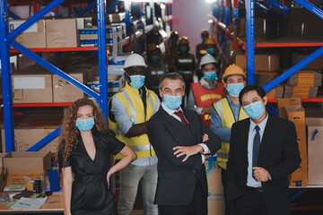 Fototapeta na wymiar Warehouse manager, working team to wear a face to prevent COVID 19. Team Cooperative Organization