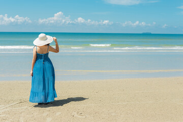 Fototapeta na wymiar asian woman in blue dress in summer on the sand on the beach of tropical island.