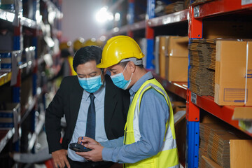 Manager with worker team working warehouse. During working hours in the warehouse, there is a checking, checking, stock for quality products, safe for customers. people worker in warehouse concept.