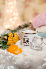 Hot chocolate with marshmallows and cinnamon, notepad, Christmas decorations on a light background. Christmas inspiration planning concept.