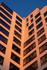 Facade of a modern light building at sunset