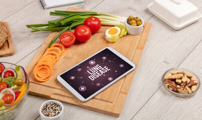 LUNG DISEASE concept in tablet pc with healthy food around, top view