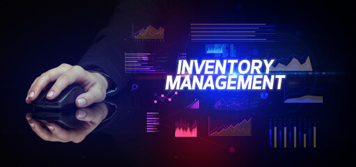 hand holding wireless peripheral with INVENTORY MANAGEMENT inscription, cyber business concept