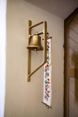 Bell by a door to a sacristy inside a church