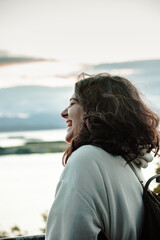 Woman portrait laughing by heart at the coast