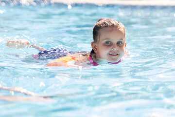 Child Girl In Swimming Pool Playing