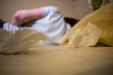 A Young Man in a White Shirt Lying Sick in Bed With Tissues