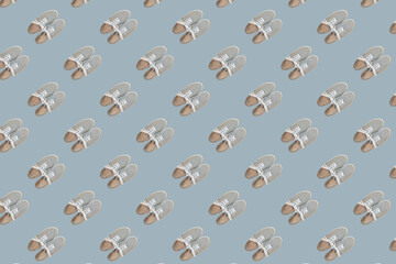 seamless pattern of grey classic sneakers on light blue  background
