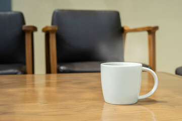 Hot coffee with smoke in the white cup on the table.day light in the moring.