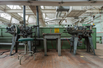 Two industrial machines sitting forgotten in an abandoned factory in the deep south