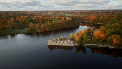 Fototapeta premium Autumn Aerial Landscapeof Old Koknese Castle Ruins and River Daugava Located in Koknese Latvia. Medieval Castle Remains in Koknese. Aerial View of an Old Stone Castle Ruins in Koknese