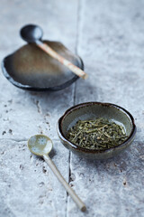 Dried Green Tea Leaves on Bright Background.	