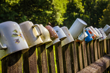 Fence decorated with cups in the garden
