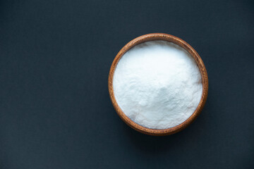 Glass bowl of baking soda. Spoonful of bicarbonate.